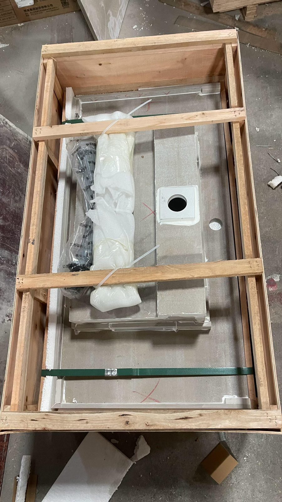 A Vora Surfaces sintered stone basin foam-wrapped inside a wooden export crate with internal framing and strapping